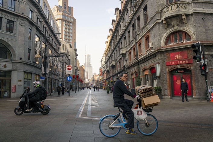 A cyclist rides through Shanghai on Monday. Photo: Bloomberg