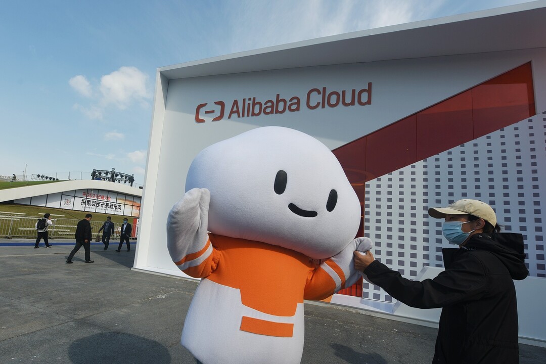 A visitor greets a mascot at Alibaba Cloud’s booth at an industry event in Hangzhou, East China’s Zhejiang province, in October 2021. Photo: VCG