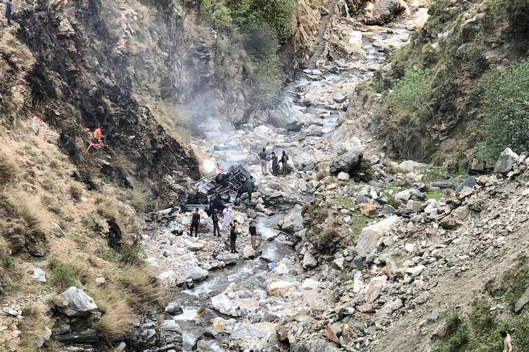 Security officials inspect the wreckage of the vehicle carrying Chinese nationals, which fell off the mountainous Karakoram Highway during the attack on Tuesday. Photo: VCG