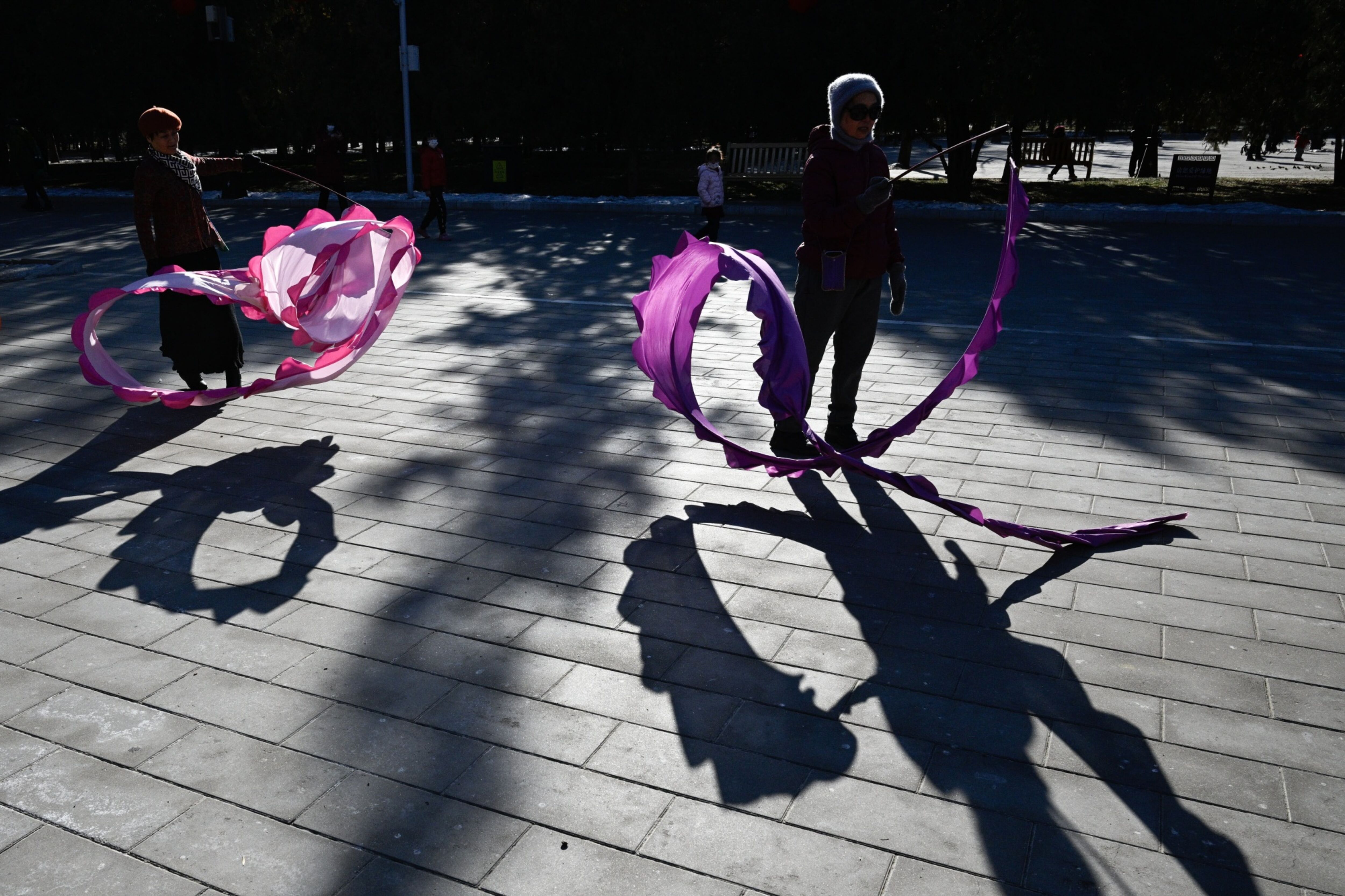 People dance with long ribbons at a park in Beijing on Jan. 24. Photo: Bloomberg