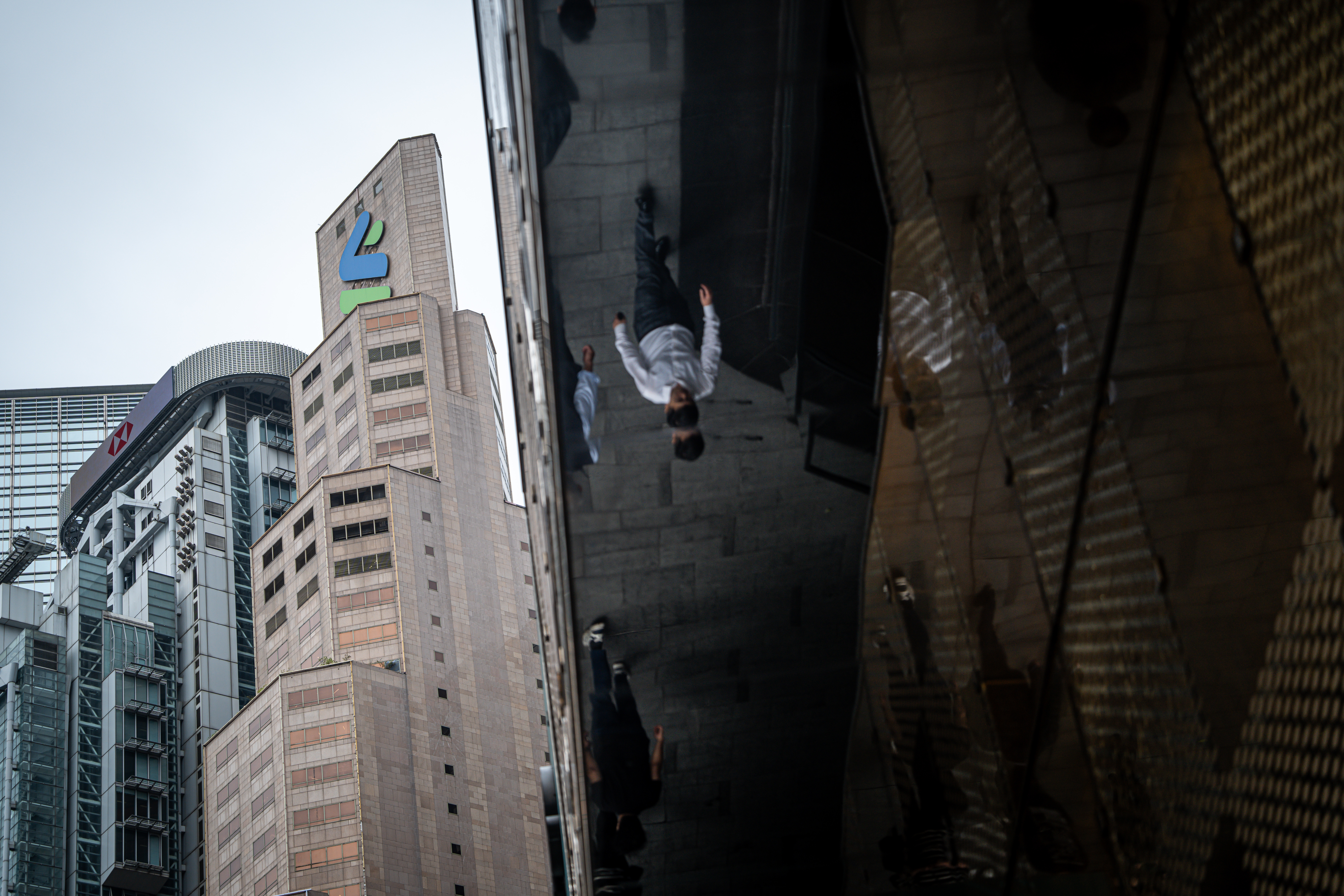 Signage atop the Standard Chartered headquarters building in Hong Kong on Feb. 19. Photo: Bloomberg